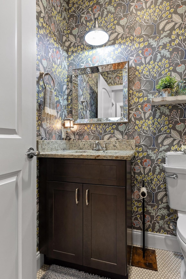 bathroom featuring vanity, toilet, and tile patterned flooring