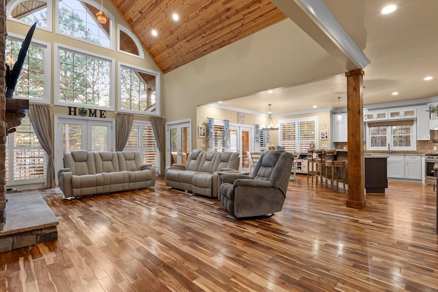 living room featuring hardwood / wood-style flooring, a wealth of natural light, a chandelier, and french doors