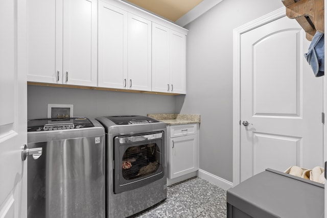 washroom featuring independent washer and dryer and cabinets