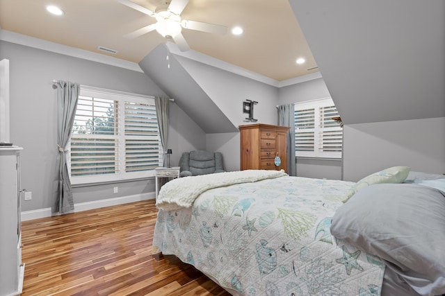 bedroom featuring hardwood / wood-style flooring, crown molding, vaulted ceiling, and ceiling fan