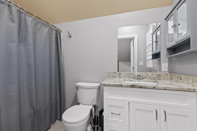 bathroom with vanity, toilet, and walk in shower