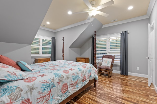 bedroom with wood-type flooring, lofted ceiling, ornamental molding, and ceiling fan