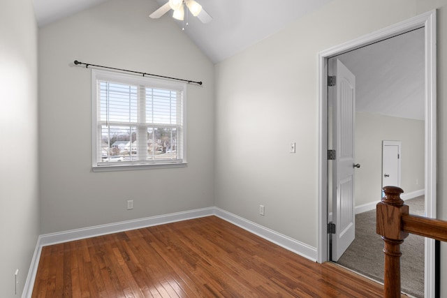 empty room featuring lofted ceiling, hardwood / wood-style floors, and ceiling fan