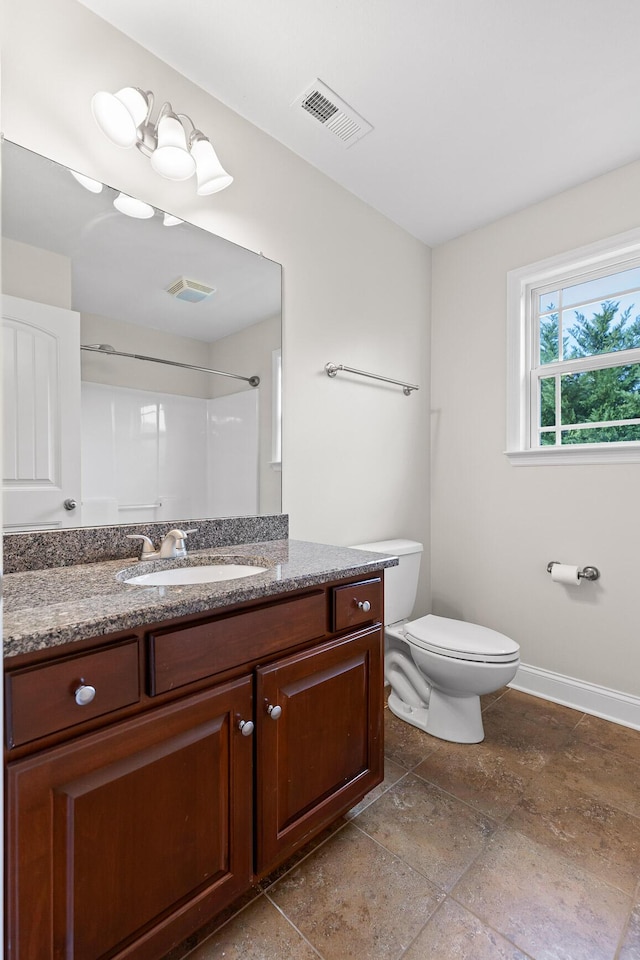 bathroom with vanity, toilet, and walk in shower