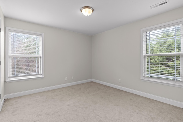 unfurnished room featuring light colored carpet