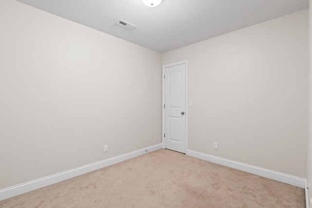 unfurnished room featuring light colored carpet