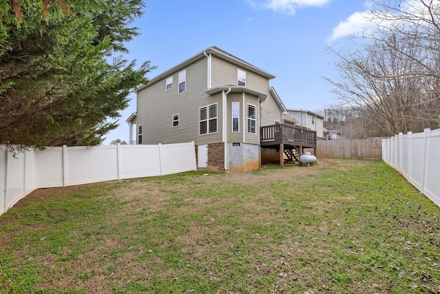 rear view of property with a deck and a lawn