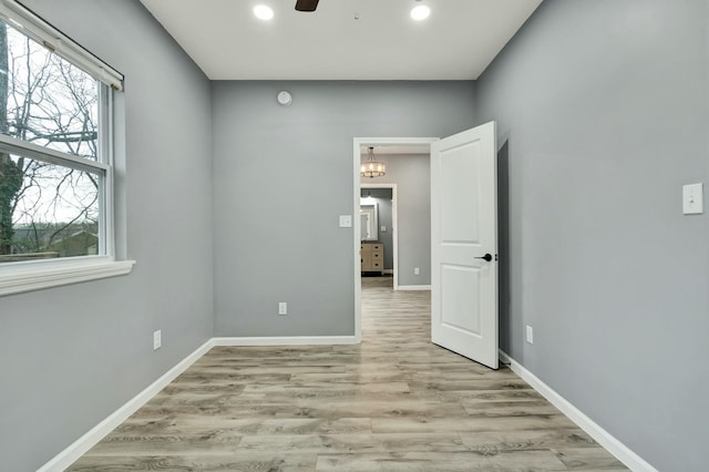 empty room featuring ceiling fan and light wood-type flooring