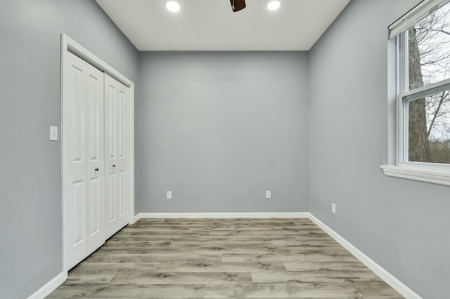 spare room featuring ceiling fan and light hardwood / wood-style floors