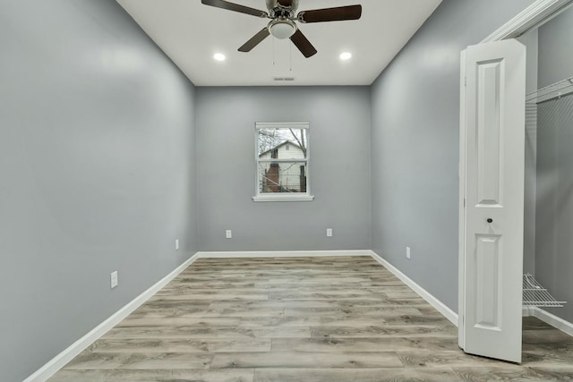 spare room with ceiling fan and light hardwood / wood-style floors