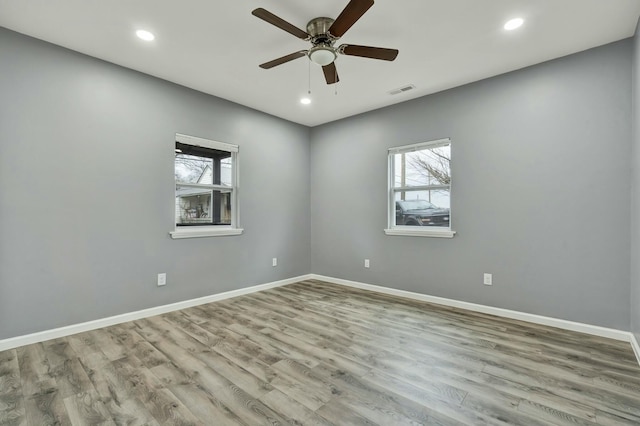 unfurnished room featuring ceiling fan and light wood-type flooring