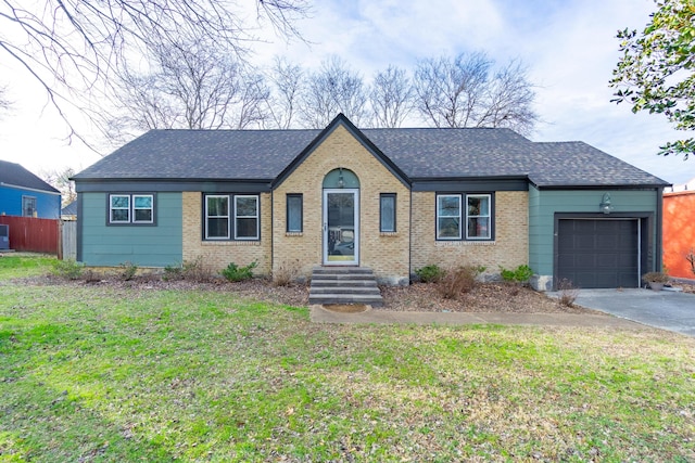 ranch-style home featuring a garage and a front yard