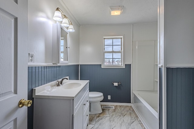 bathroom featuring vanity, a textured ceiling, and toilet