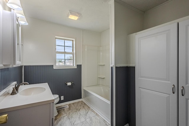 full bathroom featuring vanity, toilet, shower / bathtub combination, and a textured ceiling