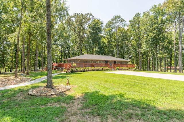 view of front facade with a deck and a front yard