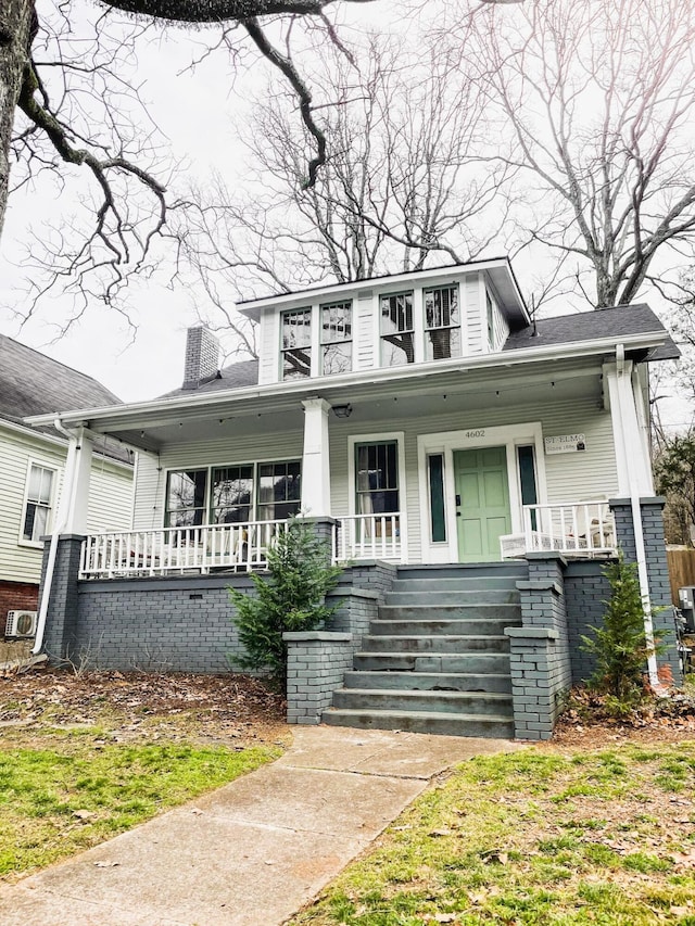 bungalow-style home featuring a porch and a chimney