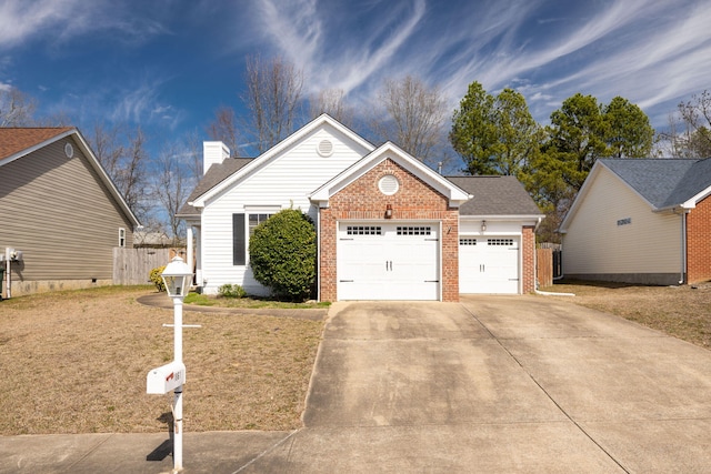 view of front of home with concrete driveway, brick siding, a front lawn, and an attached garage