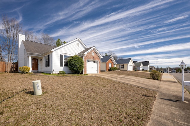 ranch-style house featuring driveway, a chimney, an attached garage, fence, and a front yard