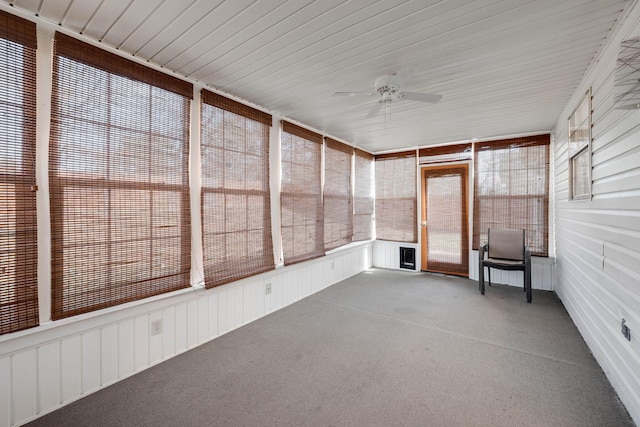 unfurnished sunroom featuring a ceiling fan