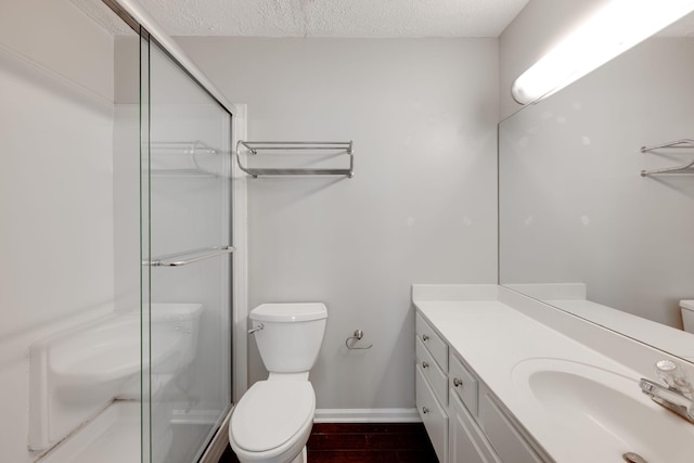 full bathroom with vanity, a stall shower, wood finished floors, and toilet