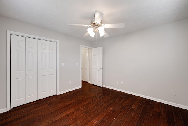 unfurnished bedroom with a ceiling fan, a closet, hardwood / wood-style flooring, and baseboards