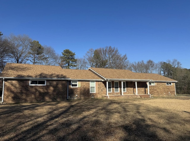 ranch-style home with a front yard and a porch