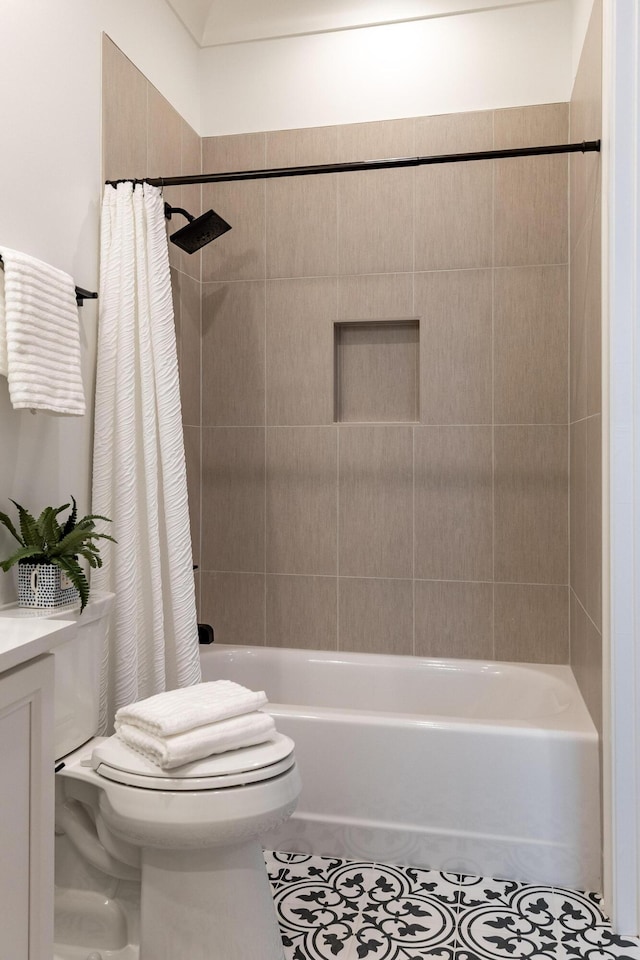 bathroom featuring shower / bath combination with curtain, tile patterned flooring, and toilet