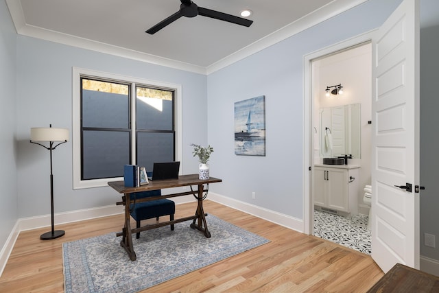 office featuring baseboards, crown molding, light wood finished floors, and ceiling fan