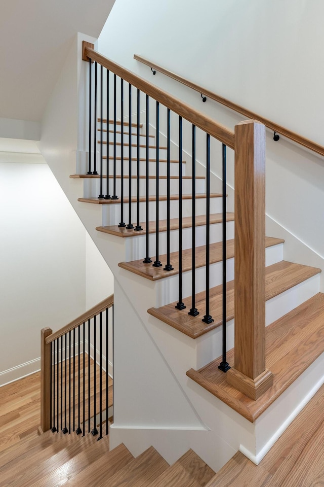 stairs featuring baseboards and wood finished floors