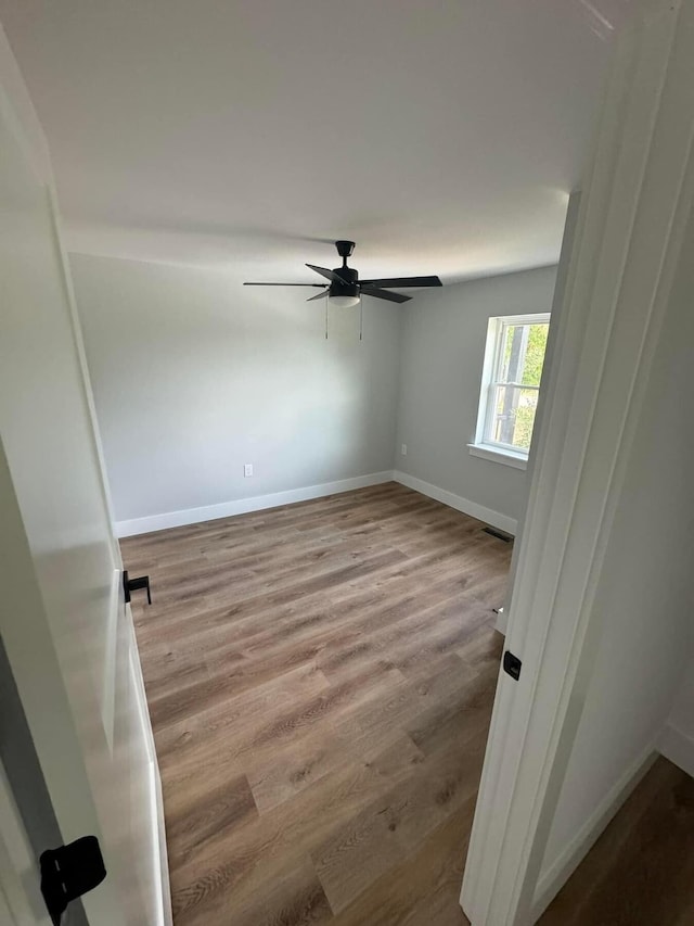 unfurnished room featuring ceiling fan and light wood-type flooring