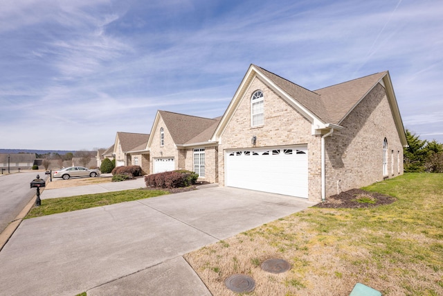 view of front of home with a front yard and a garage