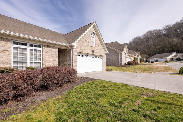 view of front of home with a front yard and a garage