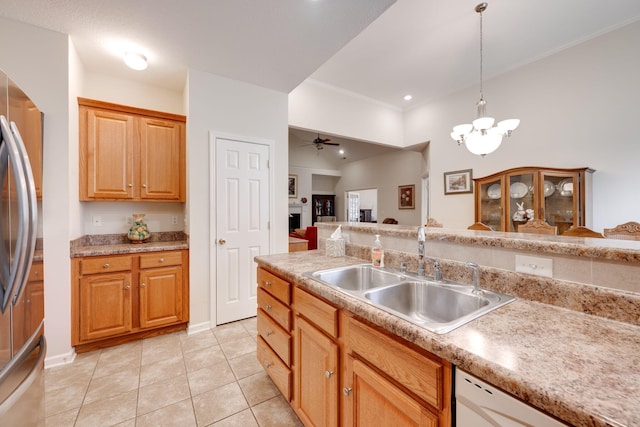 kitchen with decorative light fixtures, stainless steel refrigerator, sink, dishwasher, and ceiling fan with notable chandelier