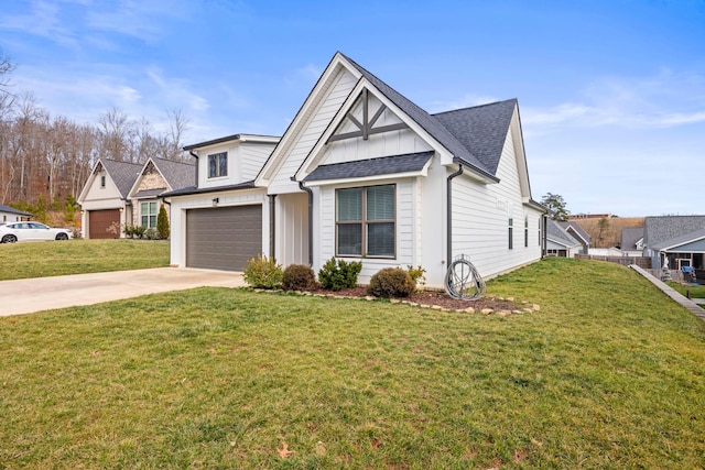 view of front of property featuring a garage and a front lawn