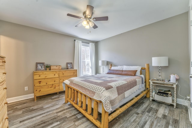 bedroom with wood-type flooring and ceiling fan