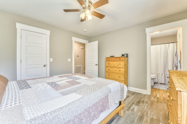 bedroom with connected bathroom, light hardwood / wood-style floors, and ceiling fan