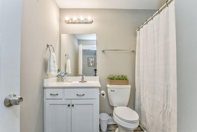 bathroom featuring vanity and toilet