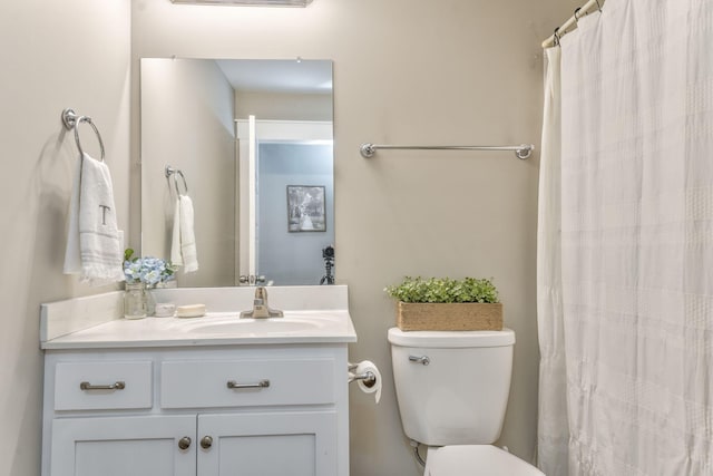 bathroom featuring vanity, a shower with curtain, and toilet