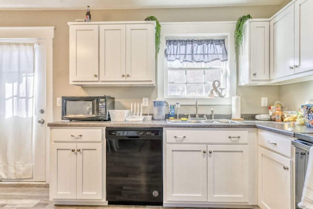 kitchen featuring sink, white cabinets, dishwasher, and light wood-type flooring