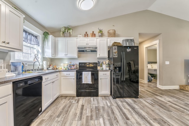 kitchen with extractor fan, vaulted ceiling, white cabinets, light hardwood / wood-style floors, and black appliances