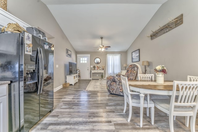 dining area with lofted ceiling, hardwood / wood-style floors, and ceiling fan