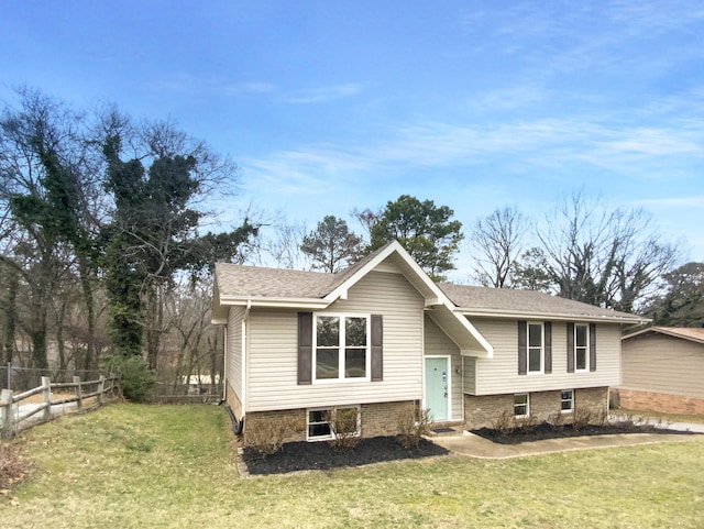 raised ranch with a front lawn