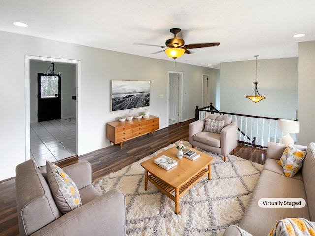 living room featuring hardwood / wood-style flooring and ceiling fan