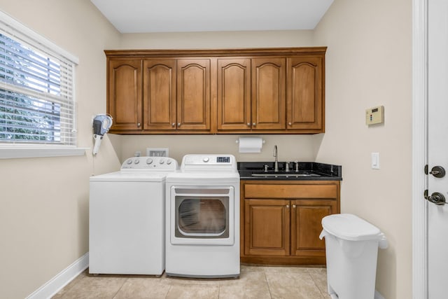 laundry room with light tile patterned flooring, cabinets, separate washer and dryer, and sink