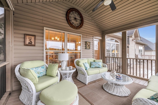 sunroom / solarium featuring lofted ceiling and ceiling fan