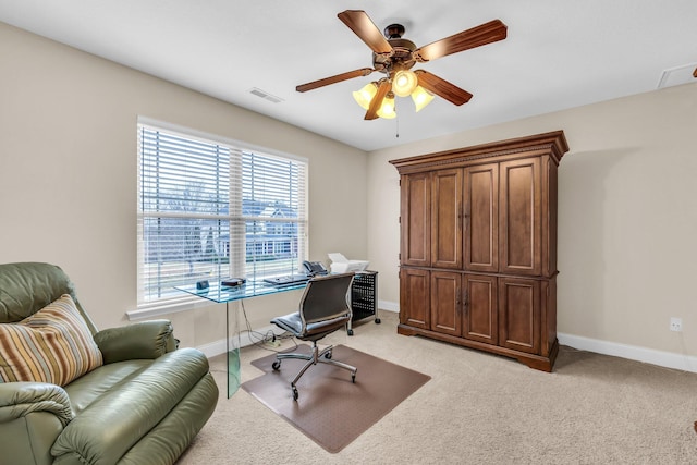 carpeted office featuring ceiling fan