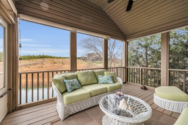 sunroom / solarium featuring a water view, lofted ceiling, and ceiling fan