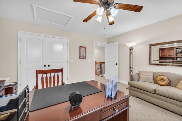 office space featuring ceiling fan and light colored carpet