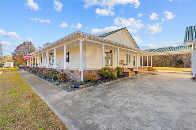 view of side of property with covered porch