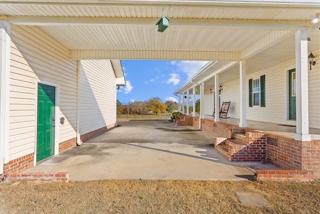 view of patio / terrace with a porch and fence